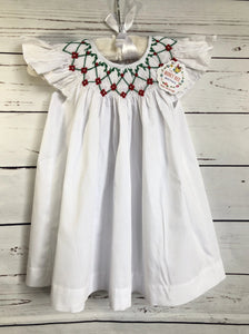 White dress with red and green smocked detail